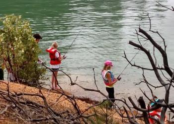 two kids fishing in a body of water