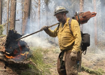 A firefighter with a chainsaw