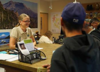 visitor center staff and visitors having conversation