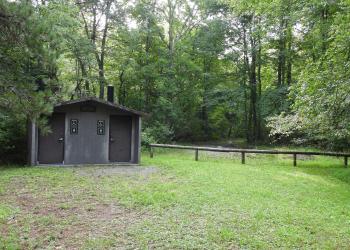 A restroom building in a forest setting