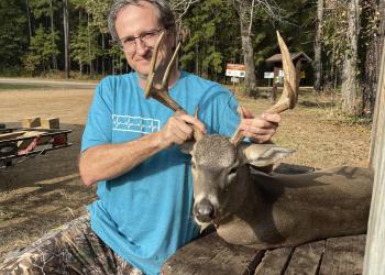 man with hunted deer