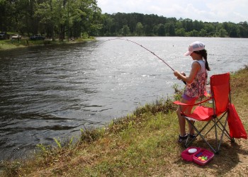 girl fishing from bank of Fullerton Lake