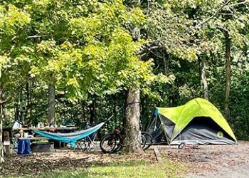 Hammock bicycle and tent at a recreation campsite