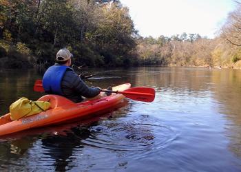 man in a canoe on the DeSoto National Forest Black Creek Wild and Scenic River