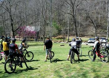 Group of Mountain Bikers in a grassy field before an event 