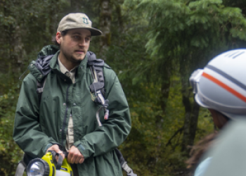 Forest Service employee with flashlight