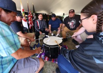 A group of Native Americans drumming.