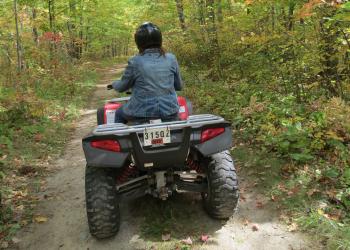 A person riding an off-road vehicle. 