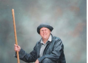 A CCC era worker holding a shovel.