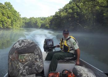 FS employee in a boat