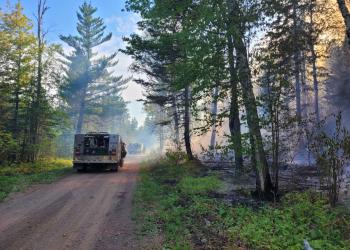 An engine on a road near a prescribed fire