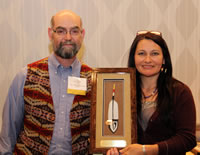 Fred Clark receiving his SAIGE award from Shana Bearhand.