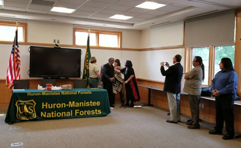 Regional Forester and Forest Supervisor honor Tribal Sub-Chief Julius Peters with Pendleton blanket.