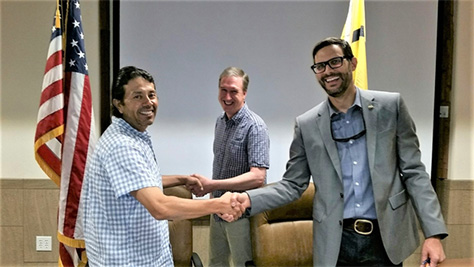 Ron Lovato shaking hands with Sean Ferrell and James Melonas.