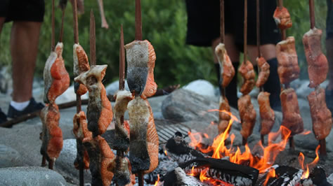 Salmon cooking at the campfire.