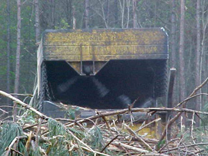 Photo of chain flail delimber in action.