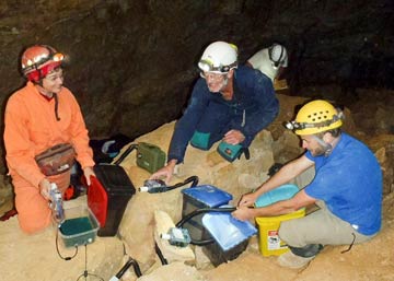 Team members deploying bat detectors and datalogging devices in Cottonwood cave on the Lincoln NF. (From left to right: D. Buecher, D. Plummer, and J. Walz. Russ Schneider, the forest fire engine captain, in background.)