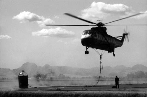 Siller Brothers S-61N helicopter taking off with helibucket