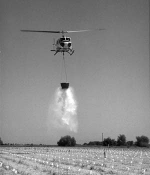 CDF Bell S205 helicopter dropping water using collapsible helibucket