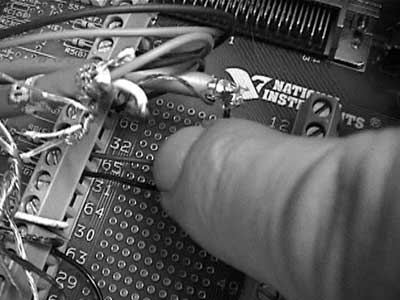 Image of a finger pressing on an electrical device.