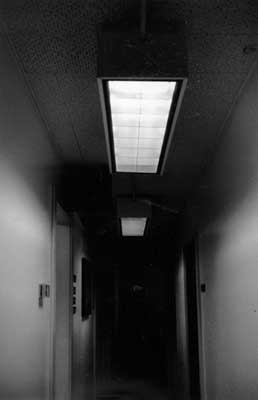 Image of a hallway with light fixtures with energy-efficient T8 fluorescent lamps and electronic ballasts.