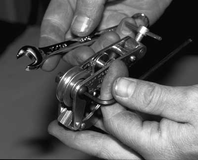 Photo of the screw being tightened with the wrench and hex key.