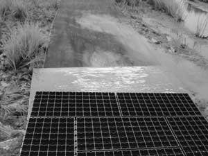 Photo of a sheet of plywood underneath the end of a panel.