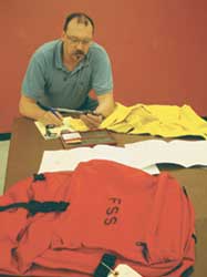 A photo of Dennis Davis inspecting products.