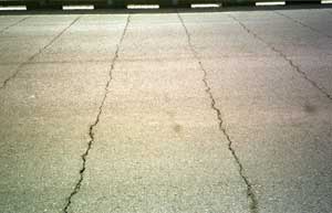 photo of cracked pavement over bridge