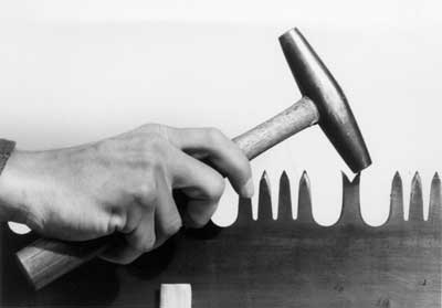 [photo] Striking the inside face of the raker tip with a hammer