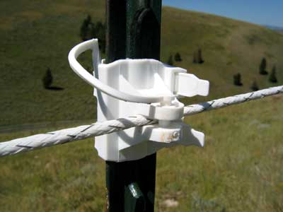 Photo of a plastic strap-on insulator that is clamped to a T-post to allow for proper spacing of polyrope. 