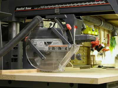 Photo of a radial saw with the proper guards and shields required for safely using this equipment. 