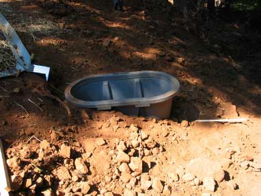 Photo of a tank surrounded by dirt.