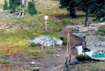 Photo of a small map attached to a staked sign.