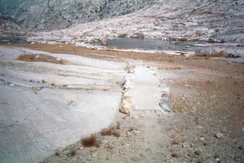 Photo of a trail that is bordered with rows of rock.