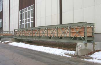 Photo of two FRP bridges lying next to a laboratory building.