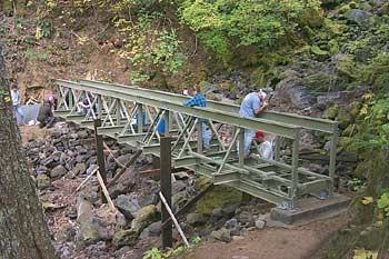 Photo of workers installing an FRP bridge.