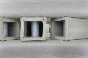 Photo of a damaged square-shaped tube joint at the top of a vertical post.