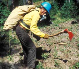 Image of a man wearing a breathing contraption while working on a fireline.