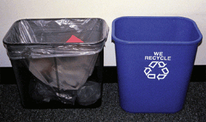 Photo of a wastebasket and a blue recycling container that has the recycling logo and it reads:  we recycle .