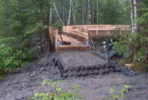 Photo of a trail leading up to a ford with a step up to a landing.