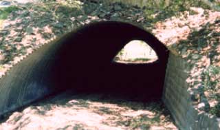Photo of a corrogated metal round culvert.