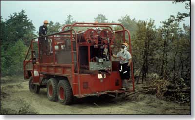 Photo of two people standing on the outside of an engine.