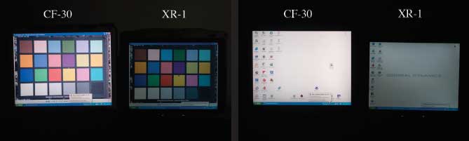 Photos of the two laptops in the dark comparing thier screens.