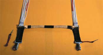 Photo of the riser, cross tie attachment, and connector links with a safety pin attachment to the reserve snaps.