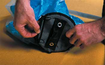 Photo of a man inserting the soft cone loops into the pilot chute.