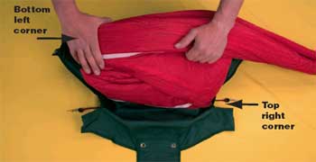 Photo of a man demonstrating how to make the first accordion fold that goes from the top right corner to the bottom left corner. In the photo the text reads, Bottom left corner and Top right corner.