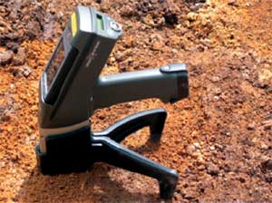 Photo of an x-ray tube device on the ground checking for heavy metals in the soil.