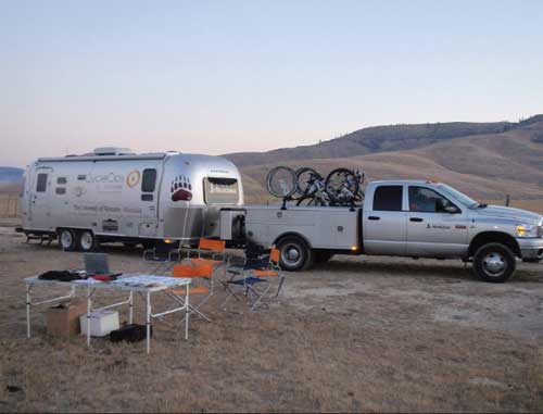 Photo of a pickup truck towing a mobile trailer that is used as a laboratory for the University of Montana's Center for Work Physiology and Exercise Metabolism.