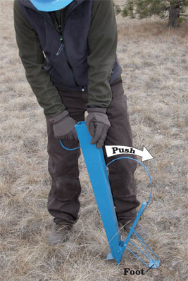 Photo of a person operating the Almaco Hand Jab. In the photo, the operator is stabbing the Hand Jab into the ground. The photo has labels that read Push and Foot.
